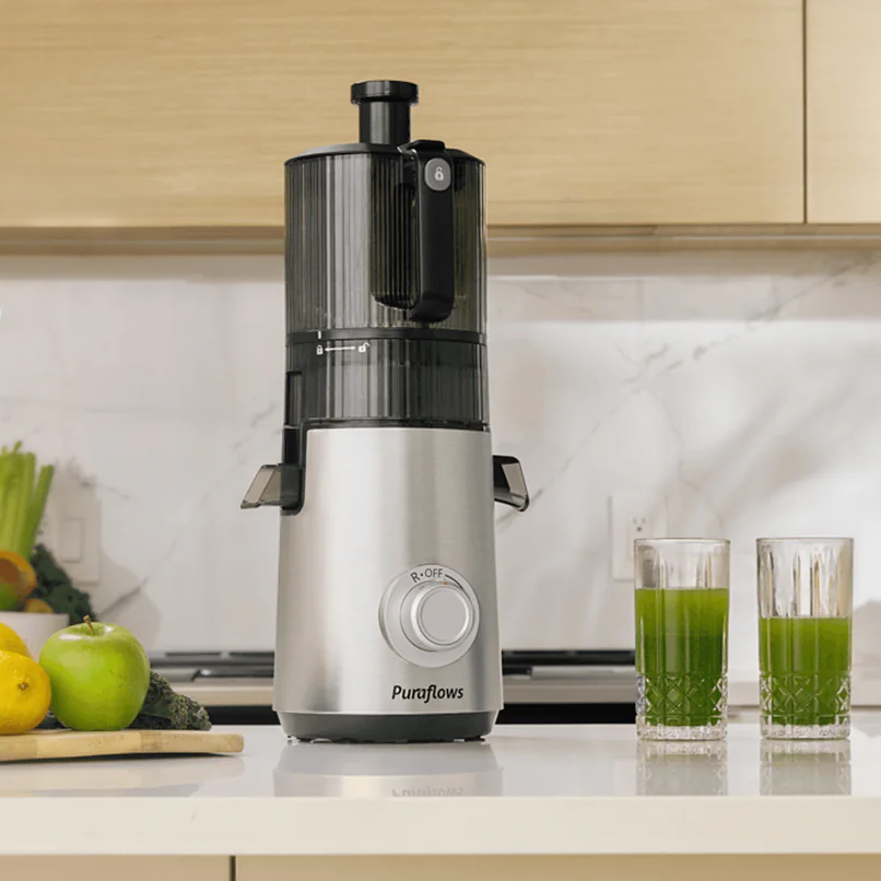 Puraflows Auramist Cold Press Juicer on a kitchen counter with fresh produce and juice