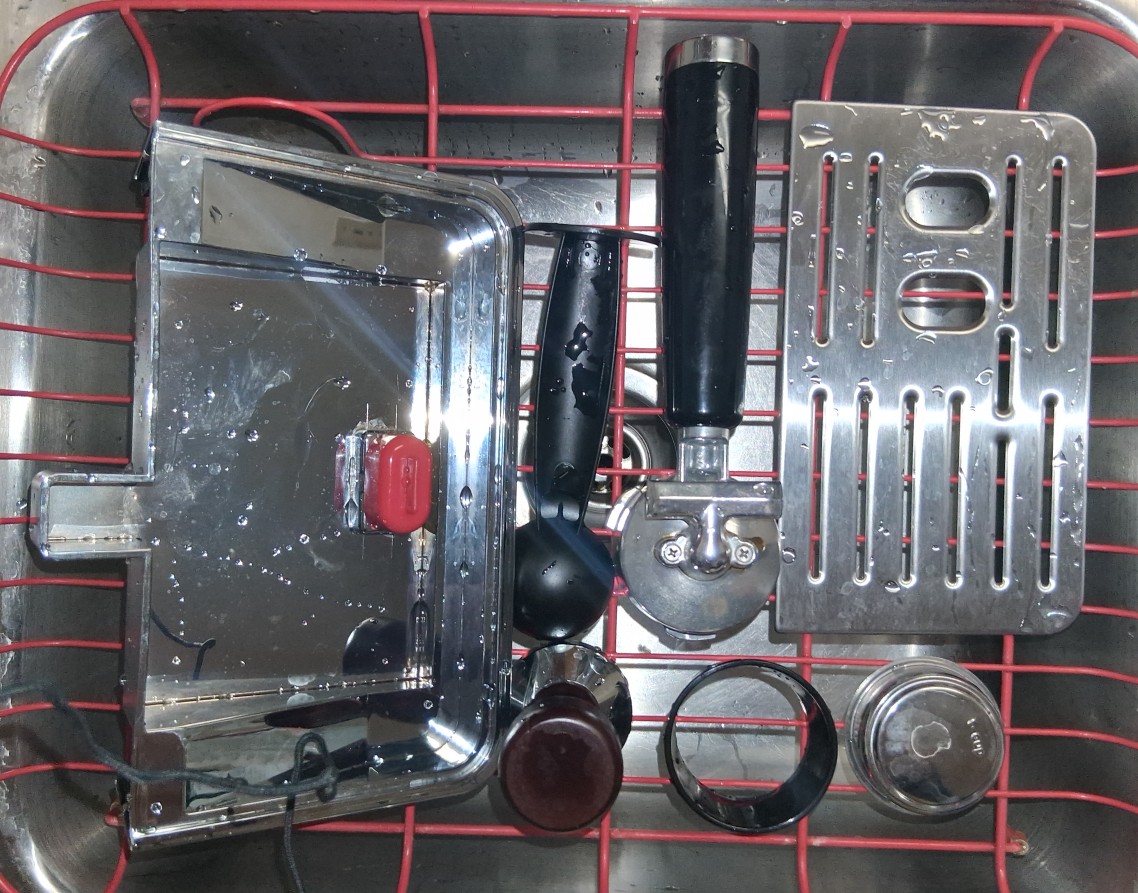 AMZCHEF CM1626 removable components and accessories, including the portafilter, drip tray, drip grate, and water tank, washed and placed on a drying rack